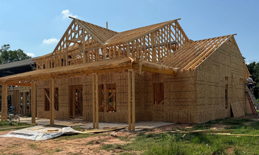 Shell of a partially built house. It is important to know what needs to be on your new construction contract checklist to know where to go from here.